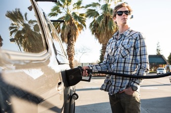 Man filling up tank of gas