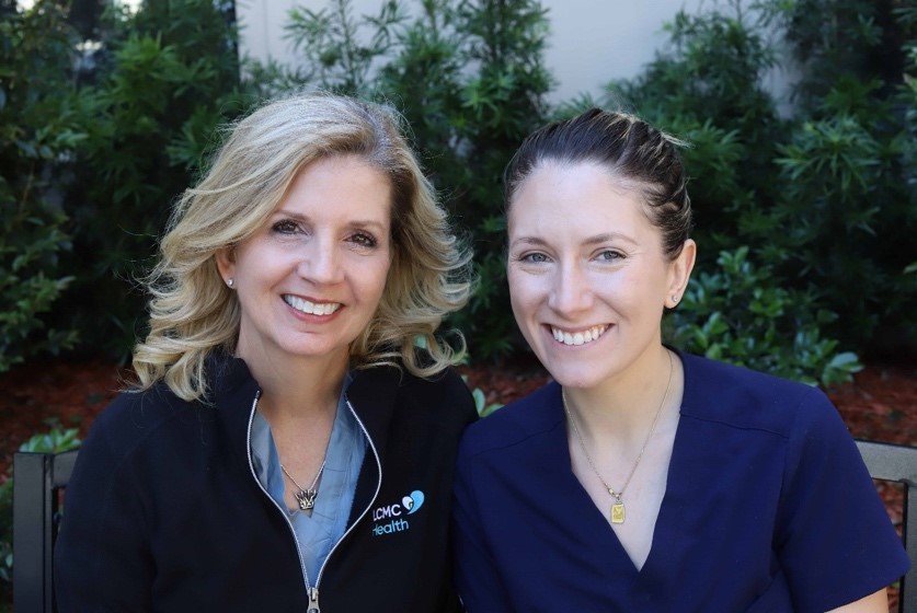A couple of women smiling
Description automatically generated with low confidence
