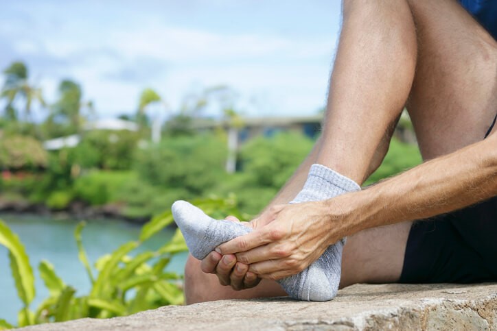 Man grabbing his foot