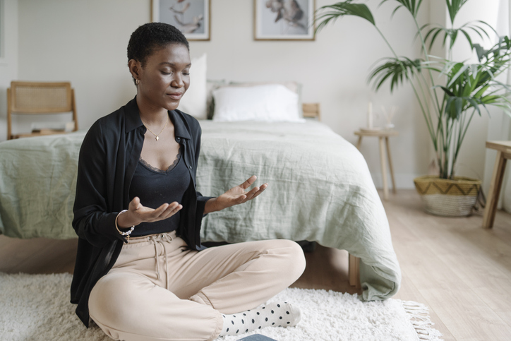 Young woman meditating on the floor