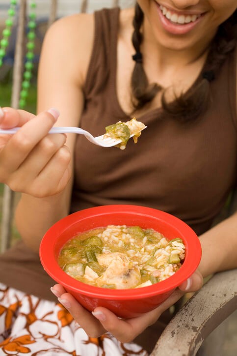 Young woman eating gumbo