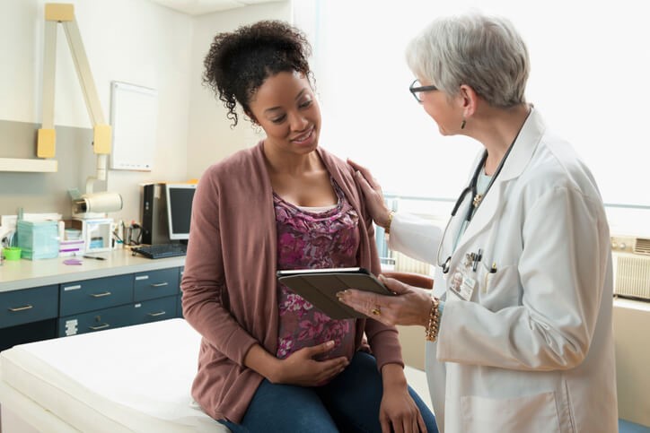 Woman reading results with doctor