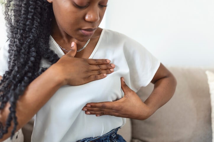 Woman doing breast exam sitting down