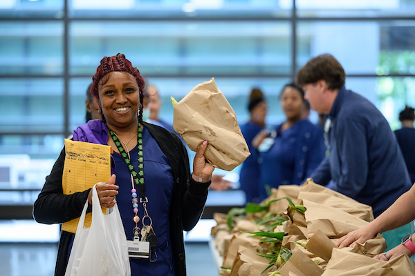 Community members collecting fresh food at a UMC food giveaway