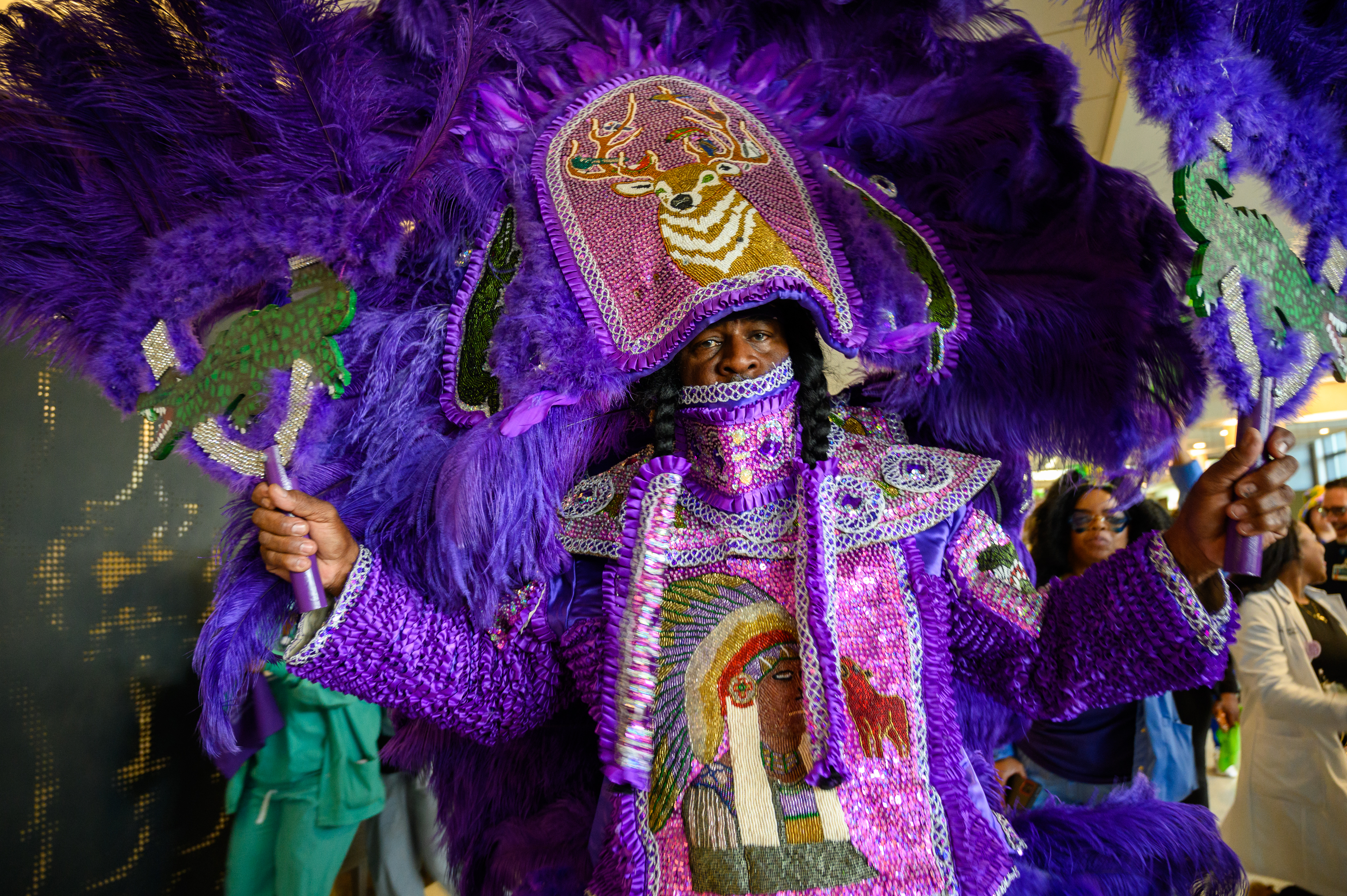 Mardi Gras Indians in full suit performing at UMC in January 2025