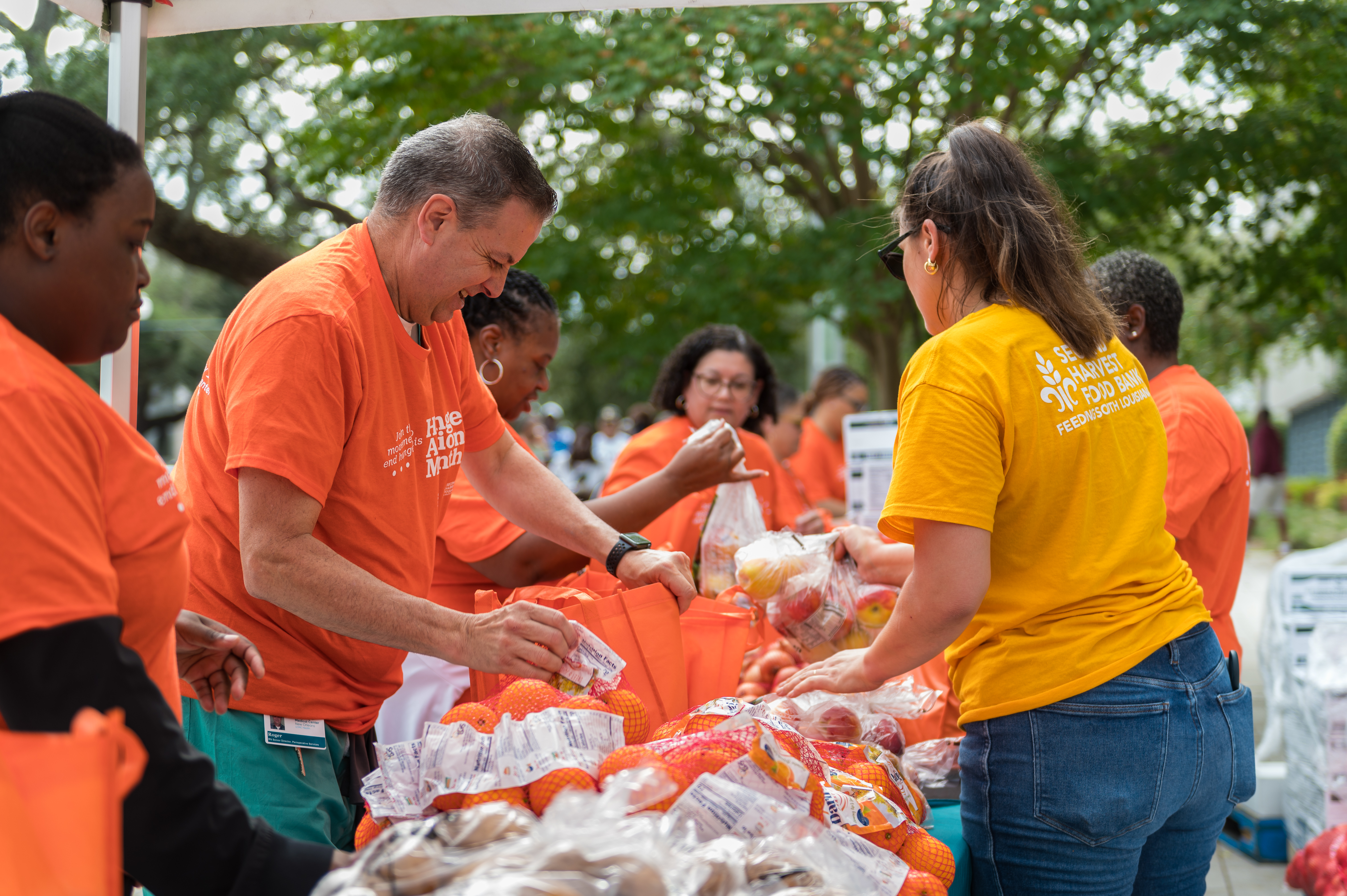 A UMC staff member talking with a community member at an outreach event