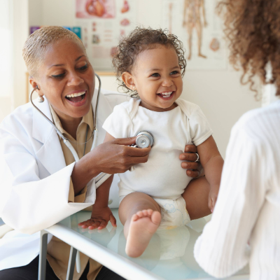 Parent holding child at pediatric visit