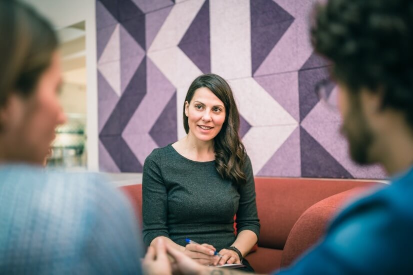 Therapist talking to clients during therapy session