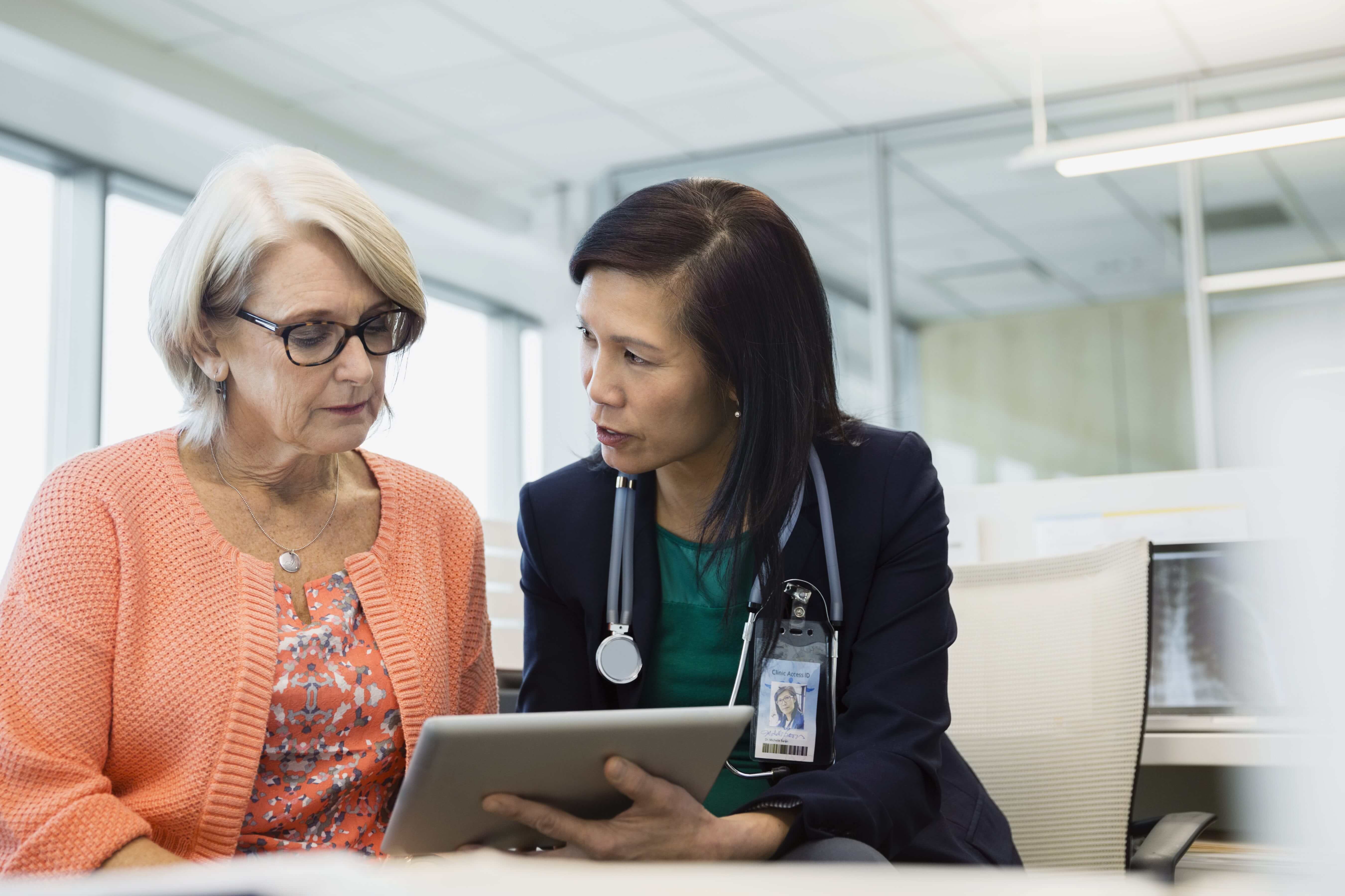 Woman explaining to an elderly lady