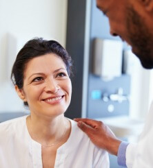 Female patient looking up and smiling at male physician