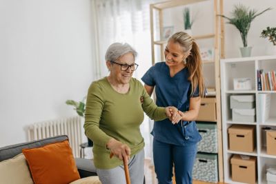 Smiling female nurse with senior female patient