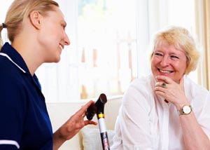 elderly woman speaking with female physician