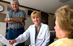 Elderly couple speaking to orthopedic physician