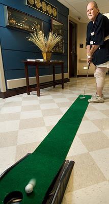 man indoor golfing during group healing