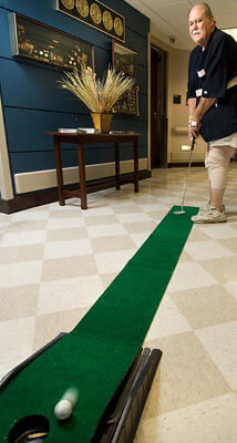 man indoor golfing during group healing