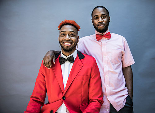 2 men in red outfits