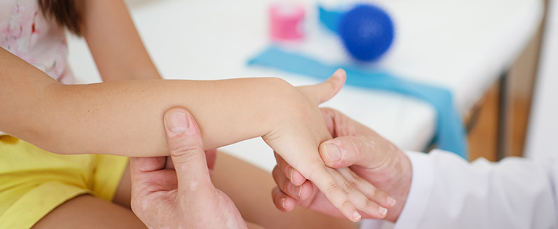 doctor examining child's wrist.