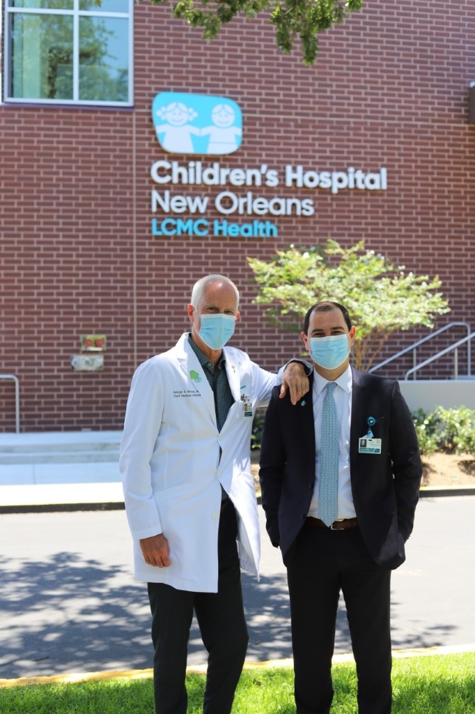 Doctors Posing in Front of Children's Hospital