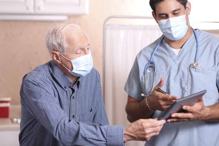 Old man talking to the nurse