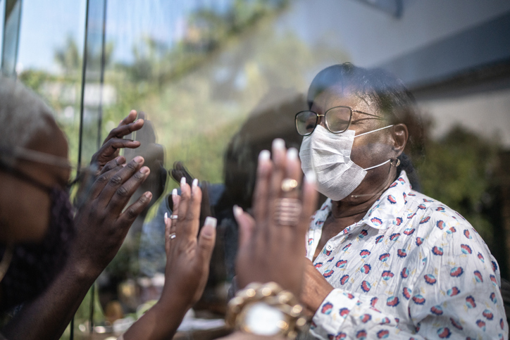 two people reaching out through the window