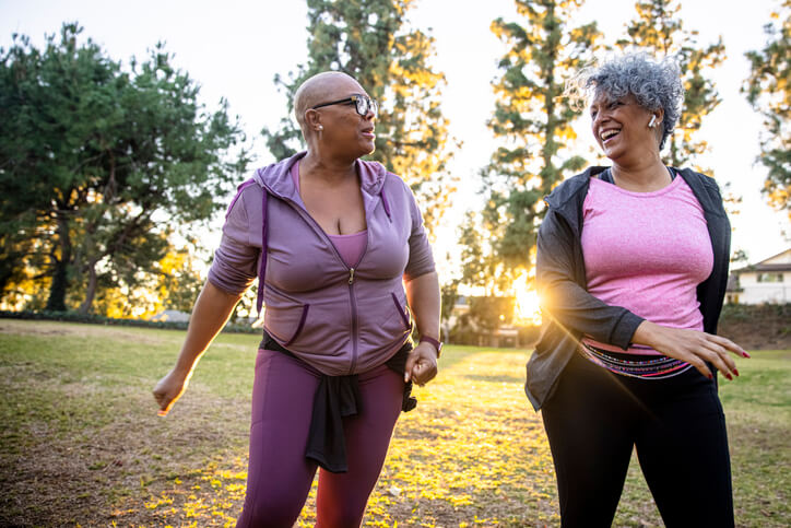 two african american women smiling and walking