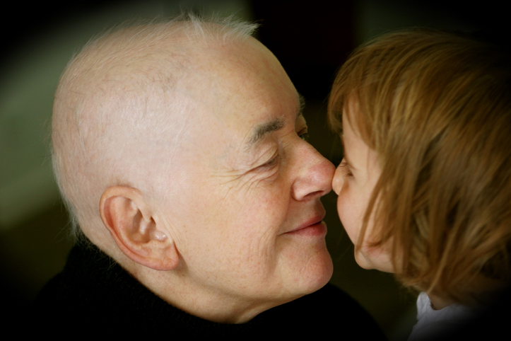 Girl and Elderly Man Touching Noses