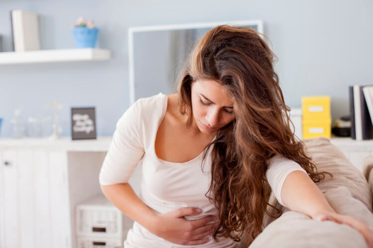 woman holding her abdomen