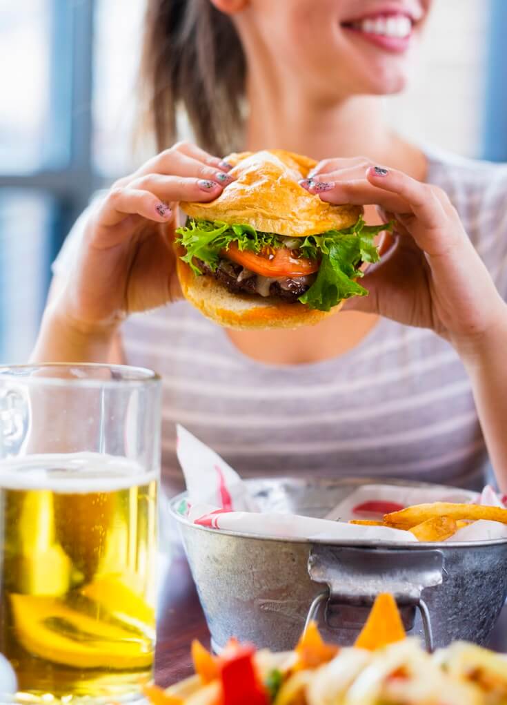 woman holding a burger