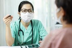 nurse sitting across from patient