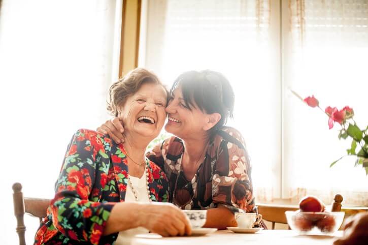 two elder women smiling