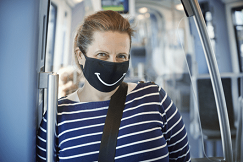 woman wearing a mask with a smiley face