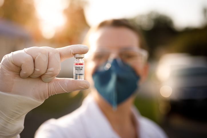 Woman holding a vaccine vial