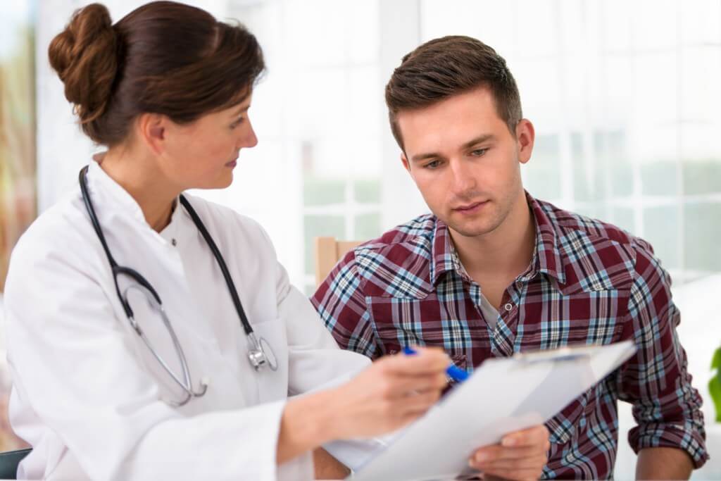 Lady physician talking to a male patient