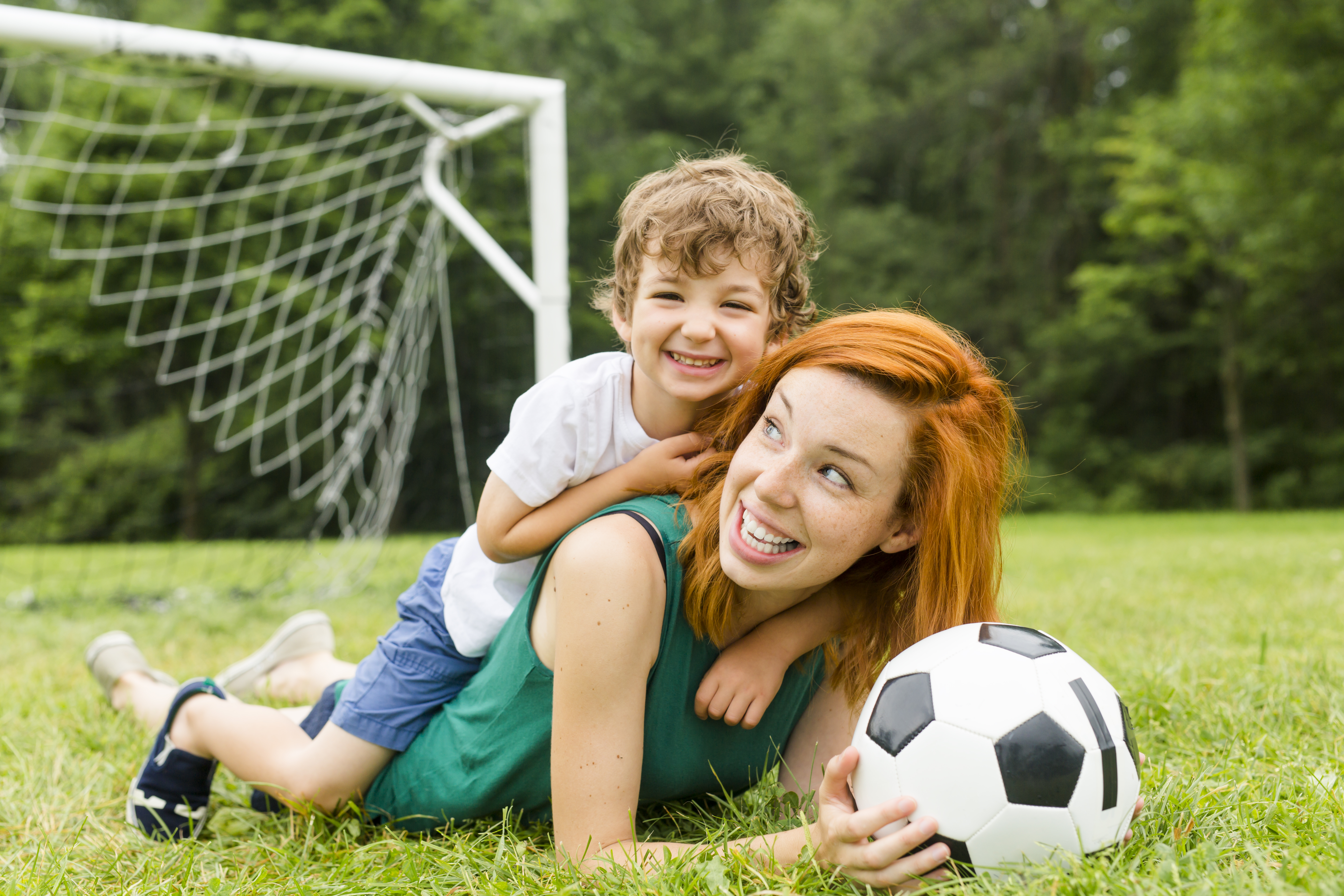 Mom and kid playing football