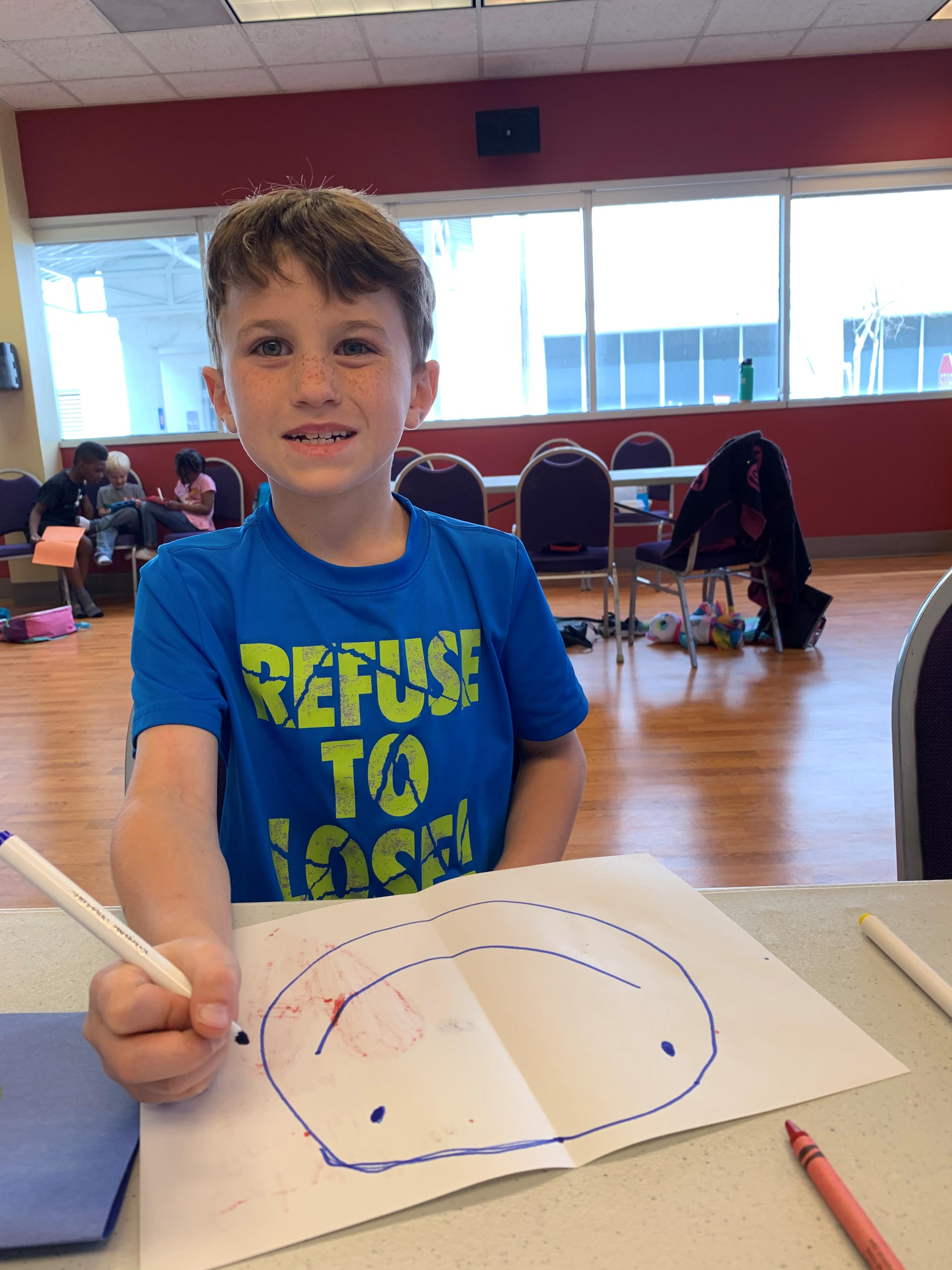 Smiling kid while drawing