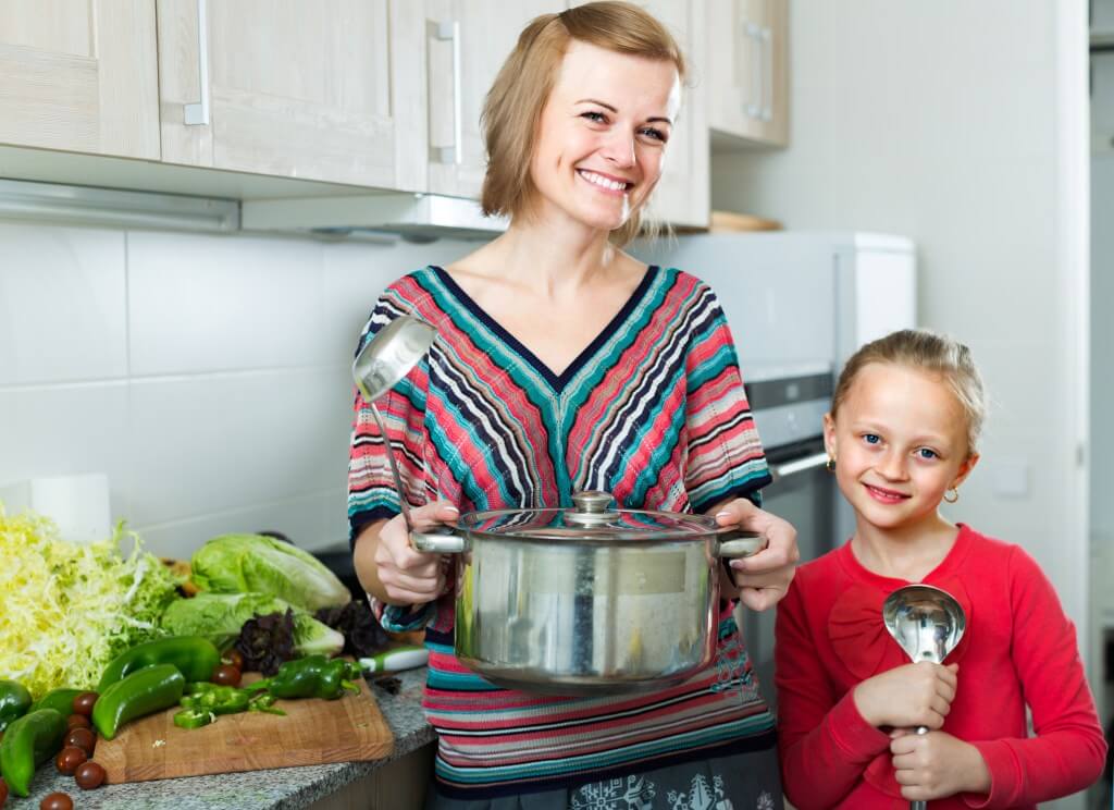 Woman and Child Smiling in Kitchen