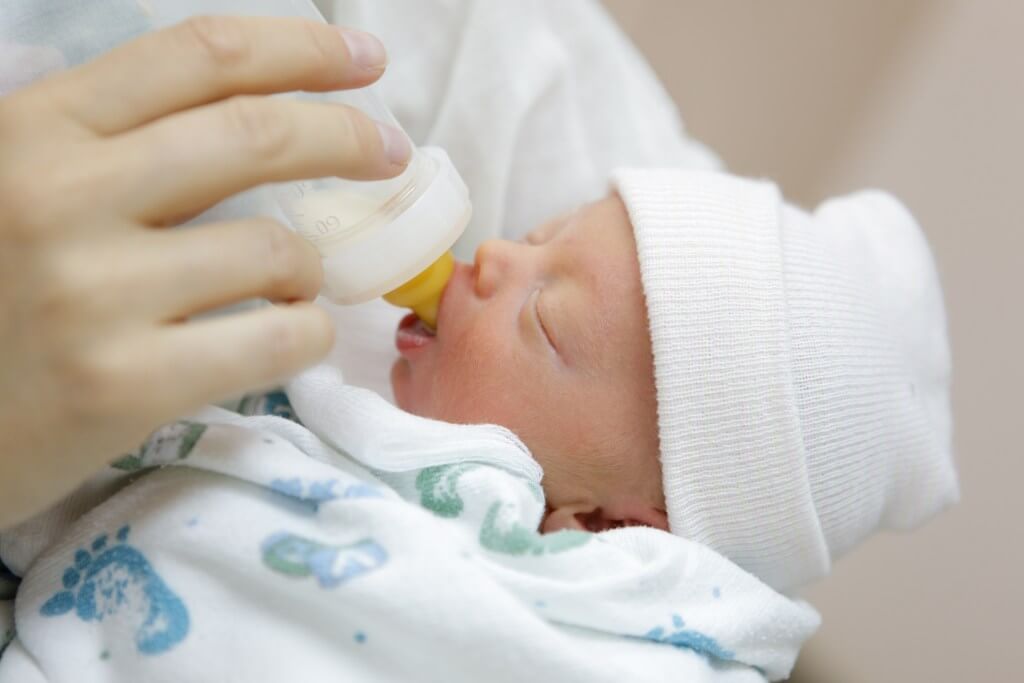 Baby being bottle fed