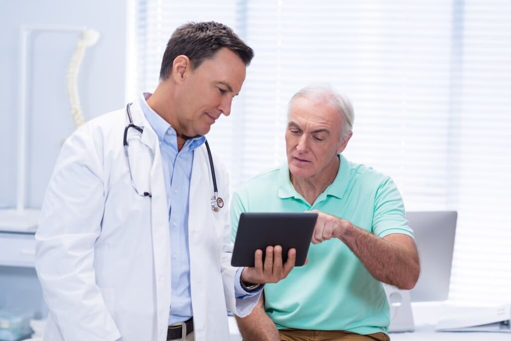 Elderly man talking to a doctor