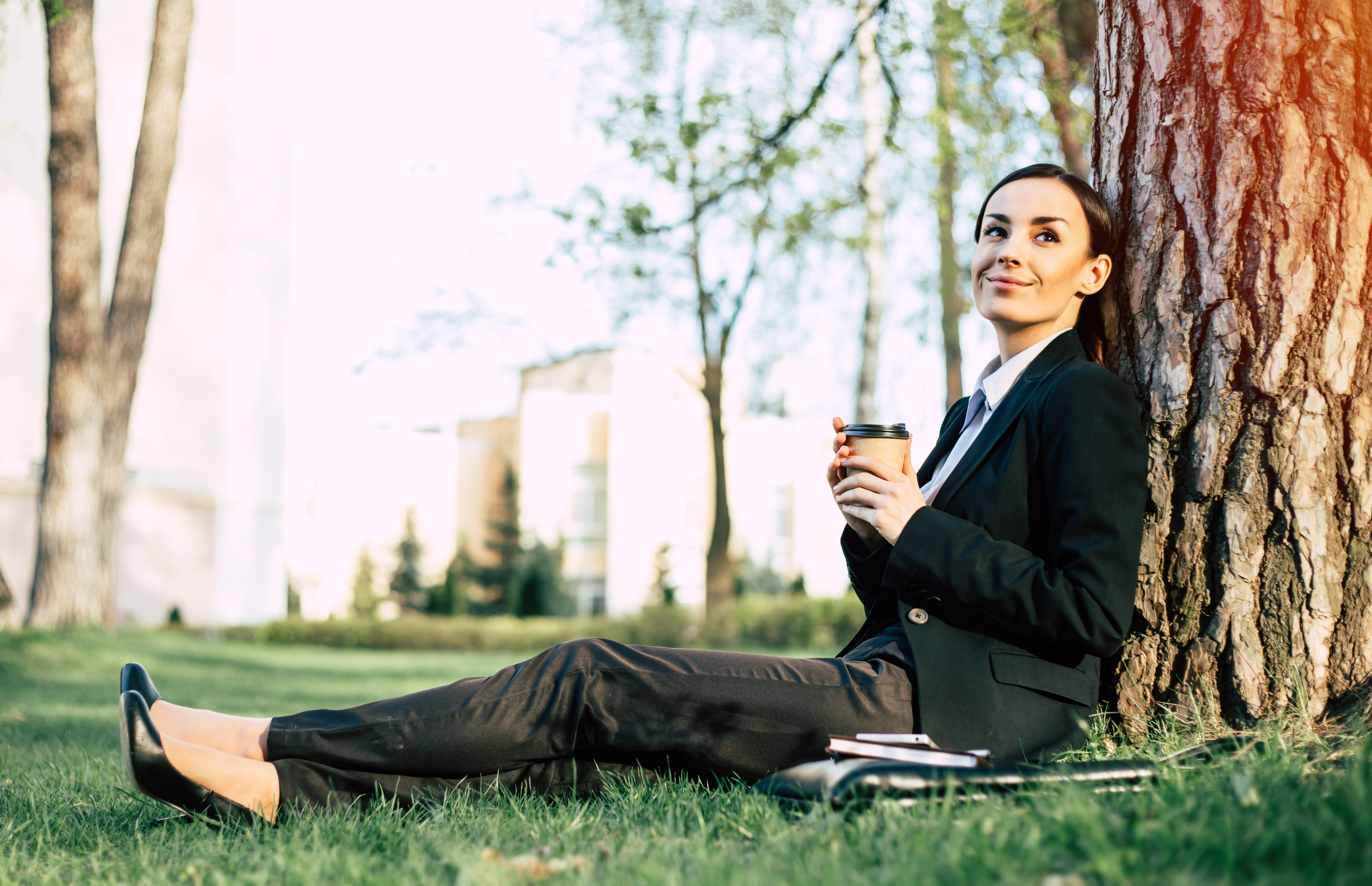 Lady relaxing by a tree