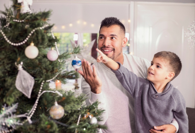 Father and son decorating Christmas tree