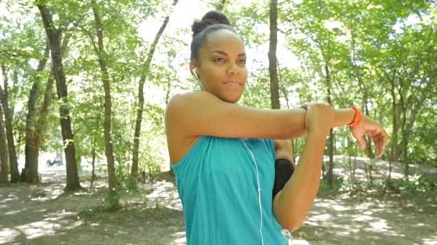 Woman stretching arms outside