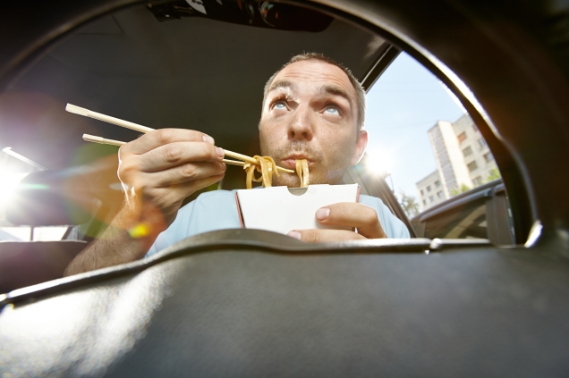 man eating and driving