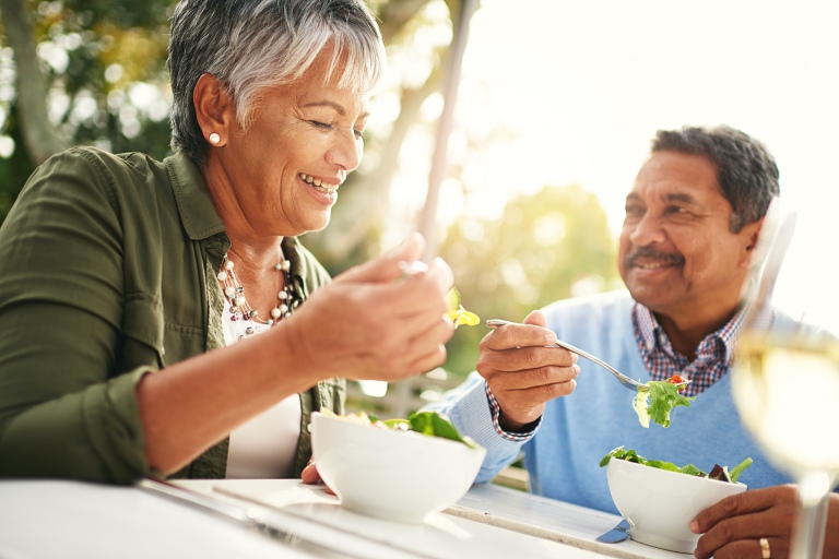 Older couple eating outdoors