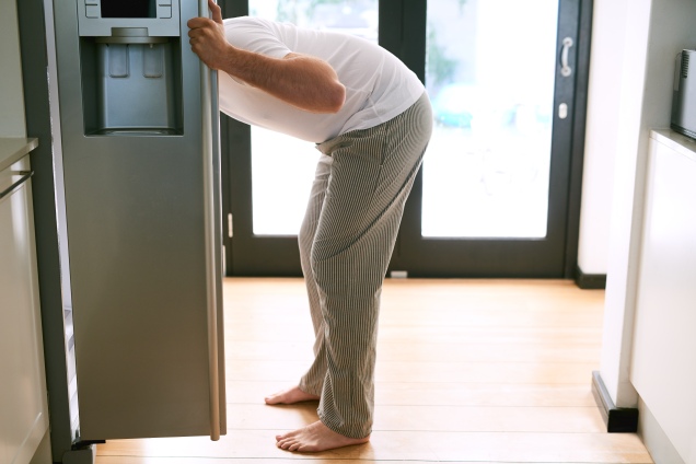 man looking in the refrigerator