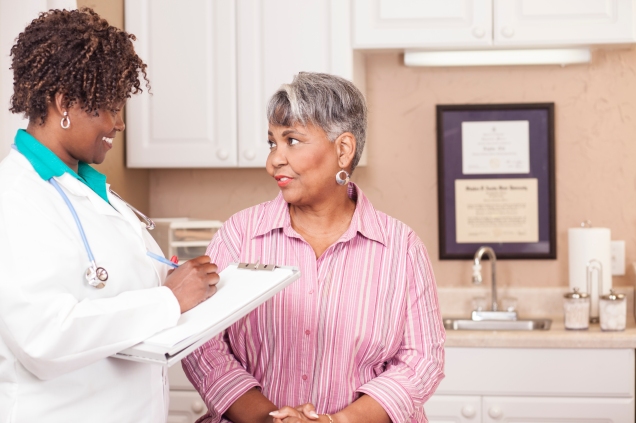 Female African American Physician speaking with female African American patient