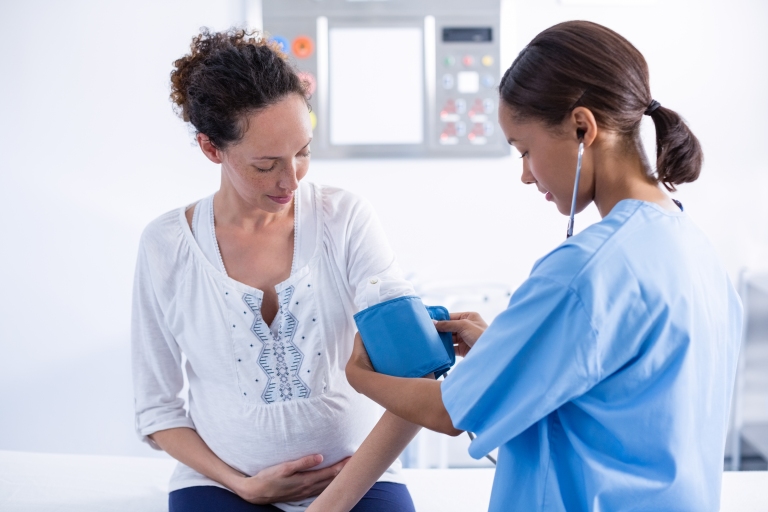 Woman getting blood pressure checked