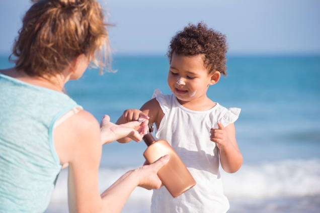 Applying sunscreen to child