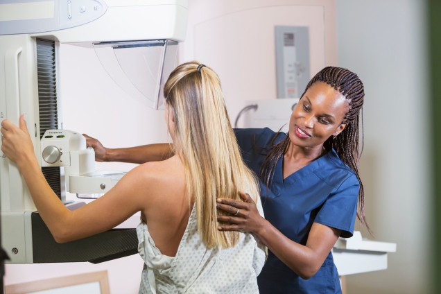 female nurse assisting with mammogram