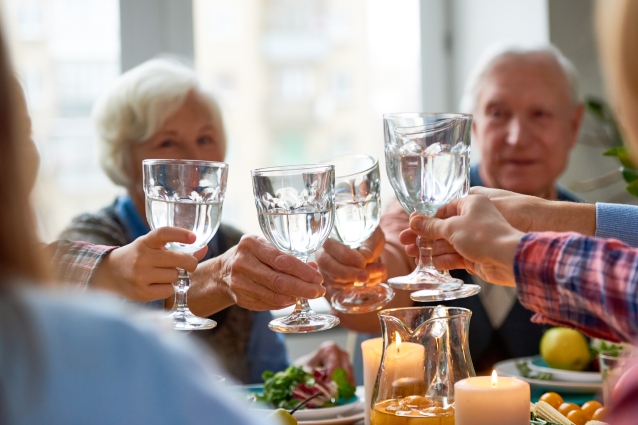 family toasting with water