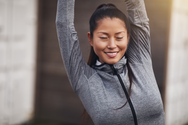 Woman stretching arms overhead